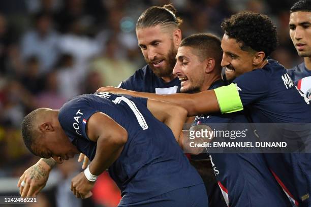 Paris Saint-Germain's French forward Kylian Mbappe celebrates with teammates after scoring his team's fourth goal during the French L1 football match...