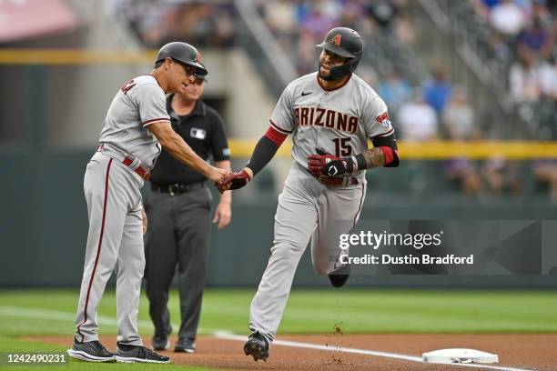 Emmanuel Rivera of the Arizona Diamondbacks is congratulated by Tony Perezchica after hitting a first inning solo home run against the Colorado...