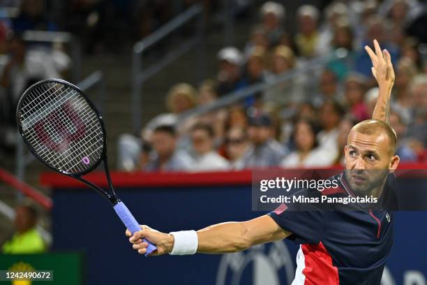 Daniel Evans of Great Britain hits a return against Pablo Carreno Busta of Spain in the semifinals during Day 8 of the National Bank Open at Stade...