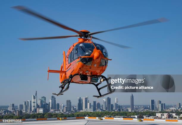 August 2022, Hessen, Frankfurt/Main: Against the backdrop of Frankfurt's banking skyline, rescue helicopter "Christoph 2" takes off on a mission. The...