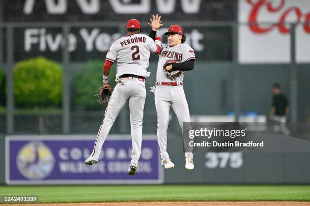 Geraldo Perdomo and Alek Thomas of the Arizona Diamondbacks jump to celebrate after a 6-0 win over the Colorado Rockies at Coors Field on August 13,...