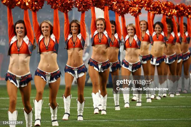 The Denver Broncos cheerleaders take the field against the Dallas Cowboys during a preseason game at Empower Field At Mile High on August 13, 2022 in...