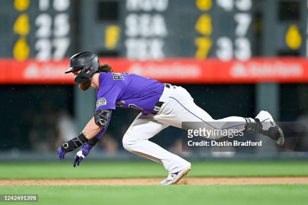 Brendan Rodgers of the Colorado Rockies slides into second base with a ninth inning double against the Arizona Diamondbacks at Coors Field on August...