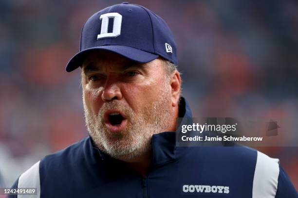 Head Coach Mike McCarthy of the Dallas Cowboys talks with his team against the Denver Broncos during a preseason game at Empower Field At Mile High...