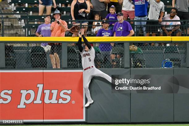 Alek Thomas of the Arizona Diamondbacks leaps to make a catch of a potential home run ball off the bat of C.J. Cron of the Colorado Rockies to end...