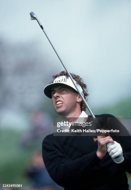 Mike Harwood of Australia after playing an iron shot during the Benson & Hedges International Open at St Mellion International Resort near Saltash,...