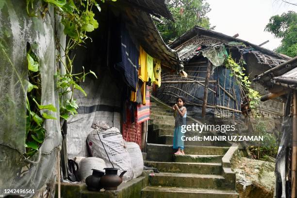 Rohingya refugee child stands outside makeshift houses in Balulkhali refugee camp in Ukhia on August 14, 2022.