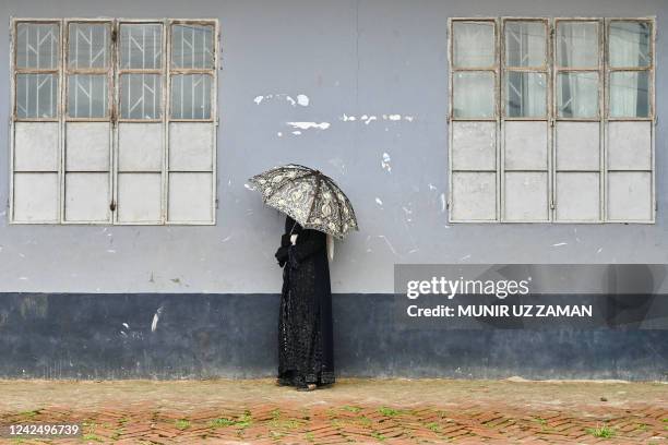 Rohingya refugee burqa-clad woman stands at the camp office in Balulkhali refugee camp in Ukhia on August 14, 2022.