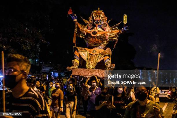 Malaysian Chinese people carry a giant paper statue of the Chinese deity "Da Shi Ye" or "Guardian God of Ghosts" during the Chinese Hungry Ghost...
