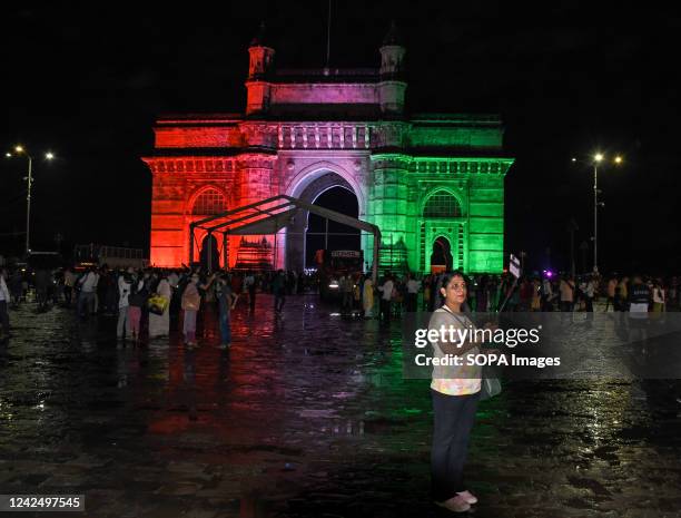 Woman takes a selfie near the Gateway of India lit up in Indian tricolour flag in Mumbai. Iconic monuments in the city are lit up in Indian tricolour...