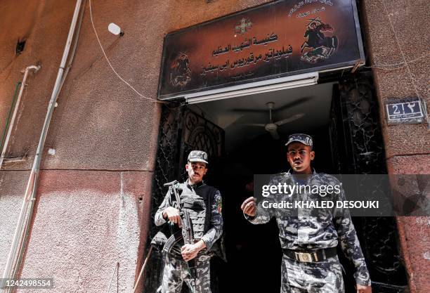 Egyptian police gather outside the Abu Sifin church located in the densely populated Imbaba neighbourhood west of the Nile river, part of Giza...