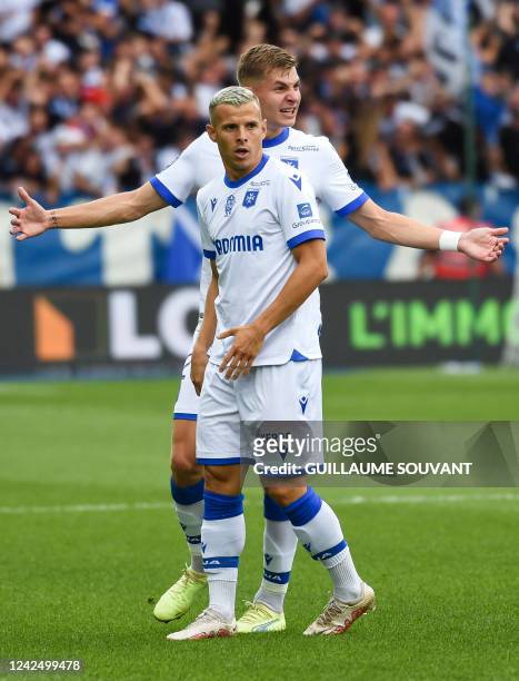 Auxerre's French midfielder Gauthier Hein , and Auxerre's French defender Paul Joly celebrate an own goal conceded by Angers' Beninese defender...