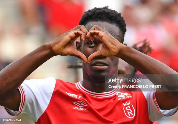 Reims' English forward Folarin Balogun celebrates after scoring a penalty kick during the French L1 football match between Stade de Reims and...