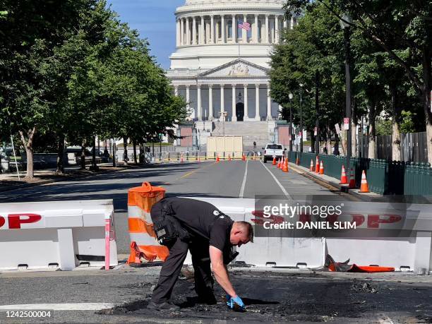 Capitol Police Officer works near a police barricade on Capitol Hill in Washington, DC, on August 14, 2022. - A man died early Sunday near the US...