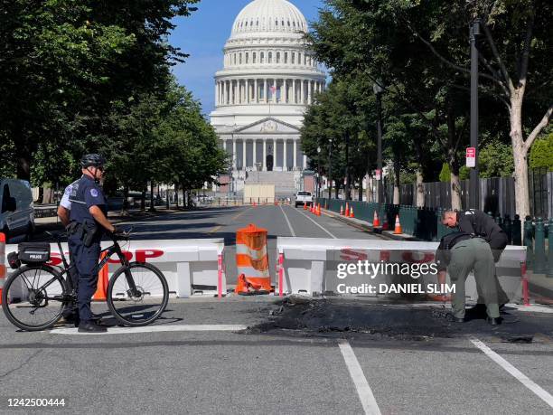Capitol Police Officers work near a police barricade on Capitol Hill in Washington, DC, on August 14, 2022. - A man died early Sunday near the US...