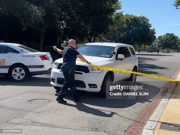 Capitol Police Officers work to close the road near the US Capitol in Washington, DC, on August 14, 2022. - A man died early Sunday near the US...