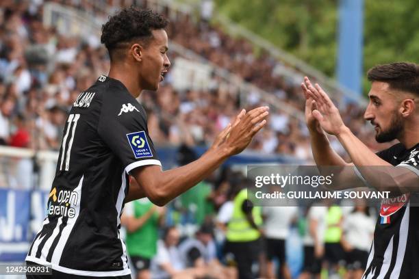 Angers' French midfielder Amine Salama celebrates his goal with his teammate Angers' Bosnian defender Halid Sabanovic during the French L1 football...