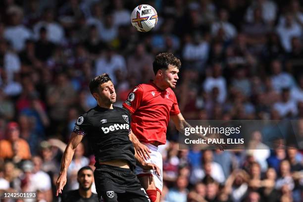 West Ham United's English defender Aaron Cresswell vies with Nottingham Forest's Welsh defender Neco Williams during the English Premier League...