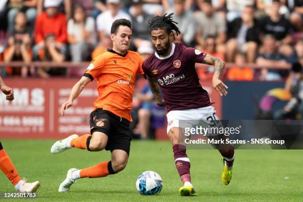 Josh Ginnelly back in action for Hearts as he's tackled by Liam Smith during a cinch Premiership match between Heart of Midlothian and Dundee United...