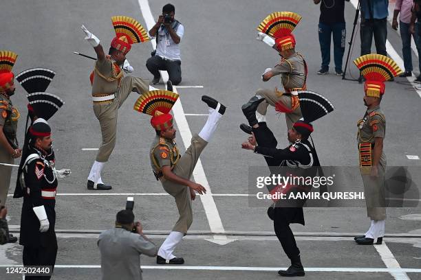 Pakistani Rangers and Indian Border Security Force soldiers take part in the Beating the Retreat ceremony during the Pakistans 75th Independence Day...