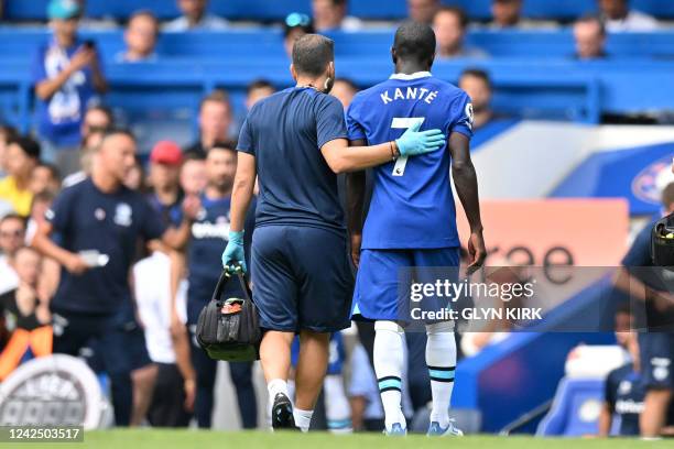 Chelsea's French midfielder N'Golo Kante leaves the game injured during the English Premier League football match between Chelsea and Tottenham...