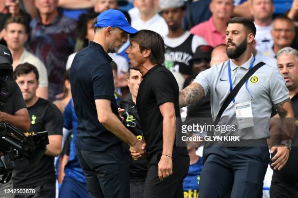 Tottenham Hotspur's Italian head coach Antonio Conte and Chelsea's German head coach Thomas Tuchel shake hands then clash after the English Premier...