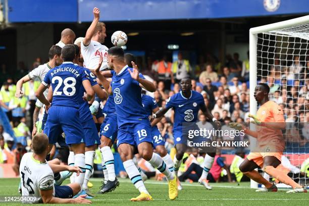 Tottenham Hotspur's English striker Harry Kane heads home their late second goal during the English Premier League football match between Chelsea and...