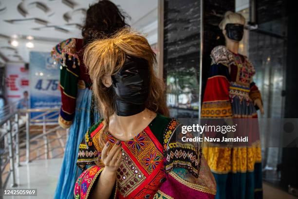 Faces are covered on female mannequins near shops on August 14, 2022 in Kabul, Afghanistan. Many murals, advertisements and mannequins featuring...