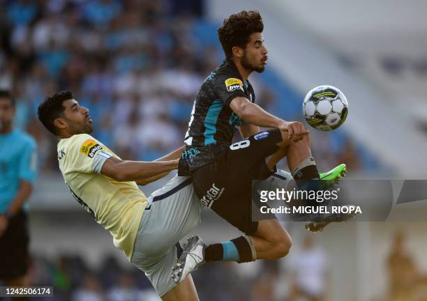 Porto's Iranian forward Mehdi Taremi vies with Vizela's Portuguese midfielder Tomas Silva during the Portuguese league football match between FC...