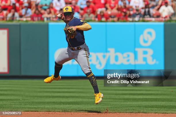 Kolten Wong of the Milwaukee Brewers throw to first base against the St. Louis Cardinals in the seventh inning at Busch Stadium on August 14, 2022 in...