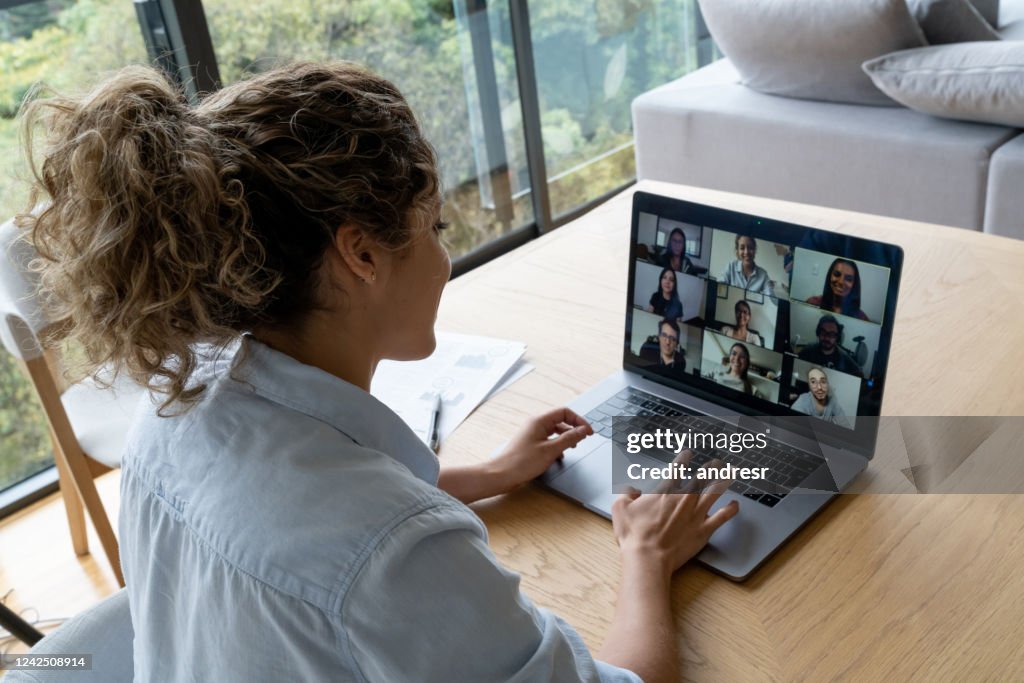 Woman in a video conference with her coworkers while working from home