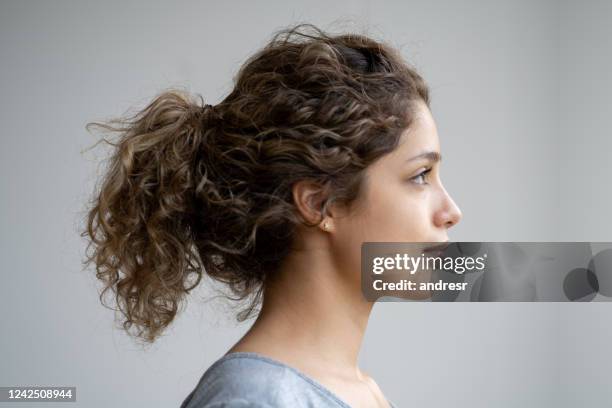 profile portrait of a serious woman with curly hair - woman profile stock pictures, royalty-free photos & images