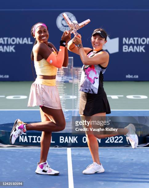 Coco Gauff of the United States and Jessica Pegula of the United States pose with the Champions Trophy following the doubles final of the National...