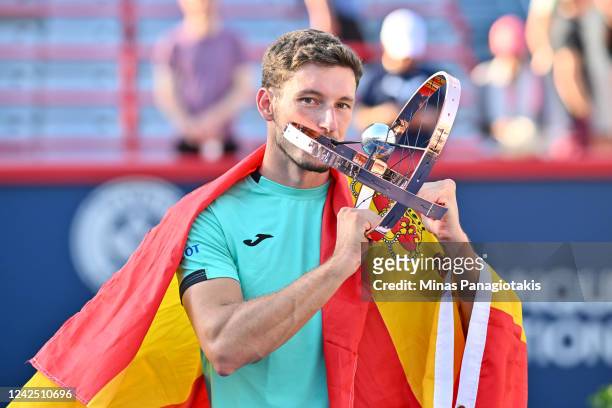 Pablo Carreno Busta of Spain kisses the National Bank Open trophy after defeating Hubert Hurkacz of Poland in the final round during Day 9 of the...