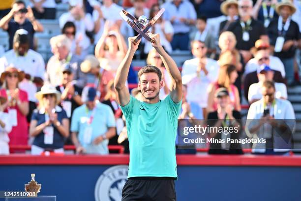 Pablo Carreno Busta of Spain holds up the trophy after defeating Hubert Hurkacz of Poland in the final round during Day 9 of the National Bank Open...