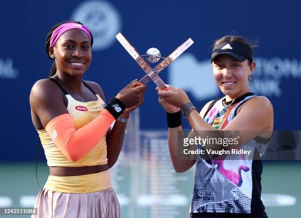 Coco Gauff of the United States and Jessica Pegula of the United States pose with the Champions Trophy following the doubles final of the National...