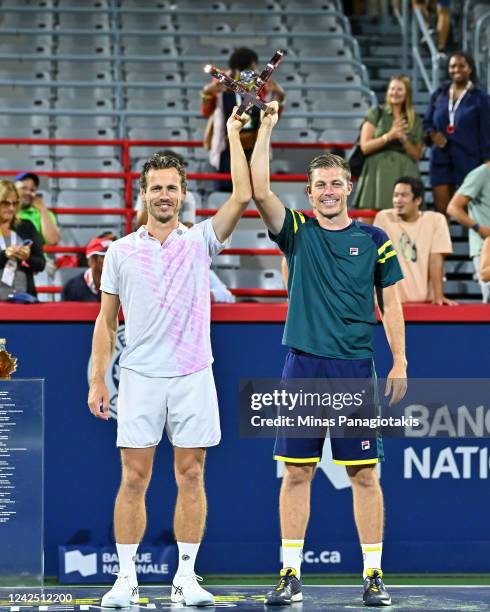 Wesley Koolhof of the Netherlands and Neal Skupski of Great Britain pose with their doubles championship trophy after defeating Daniel Evans of Great...