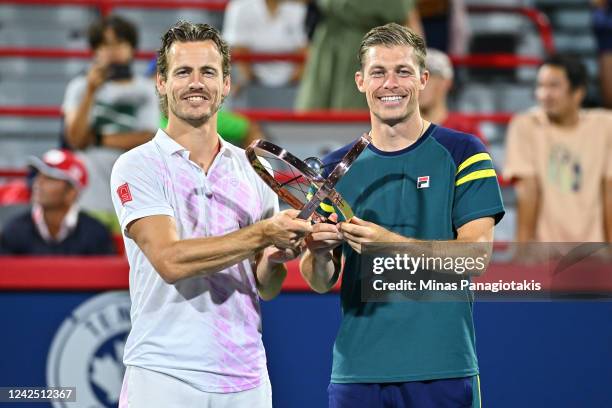 Wesley Koolhof of the Netherlands and Neal Skupski of Great Britain pose with their doubles championship trophy after defeating Daniel Evans of Great...