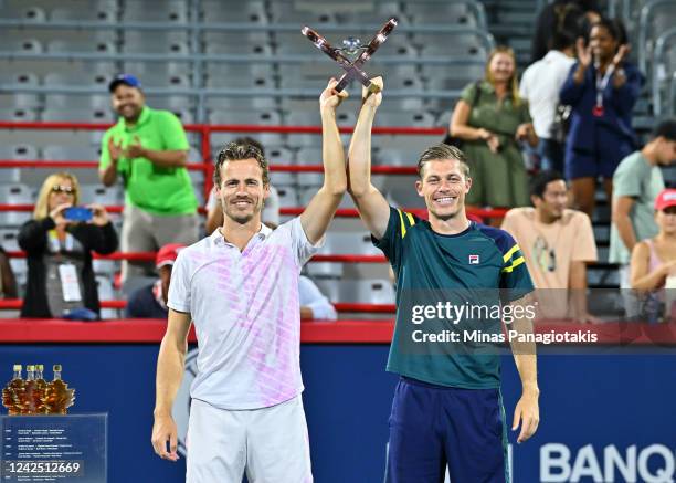 Wesley Koolhof of the Netherlands and Neal Skupski of Great Britain pose with their doubles championship trophy after defeating Daniel Evans of Great...