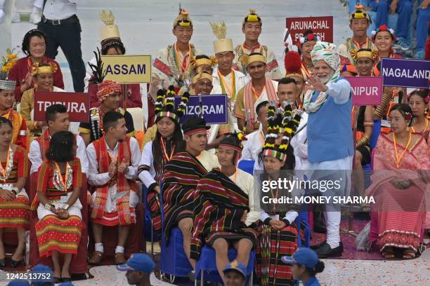 India's Prime Minister Narendra Modi greets the participants after addressing the nation from the ramparts of the Red Fort during the celebrations to...