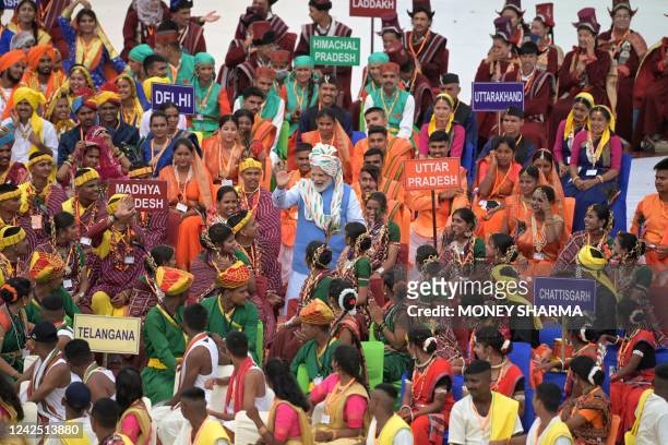 India's Prime Minister Narendra Modi greets the participants after addressing the nation from the ramparts of the Red Fort during the celebrations to...