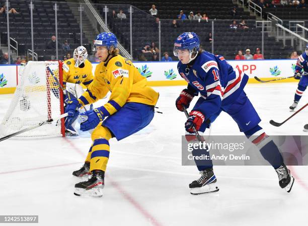 Logan Cooley of United States races for the puck against Simon Edvinsson of Sweden in the IIHF World Junior Championship on August 14, 2022 at Rogers...