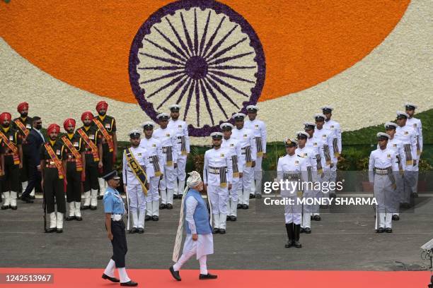 India's Prime Minister Narendra Modi inspects a guard of honour before addressing the nation from the ramparts of the Red Fort during the...