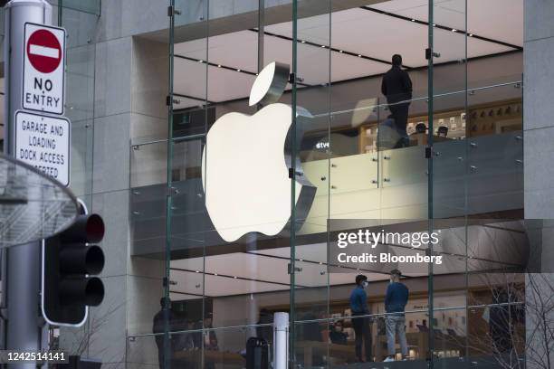 An illuminated Apple Inc. Logo outside a store in Sydney, Australia, on Sunday, Aug. 14, 2022. Australias consumer confidence declined for nine...