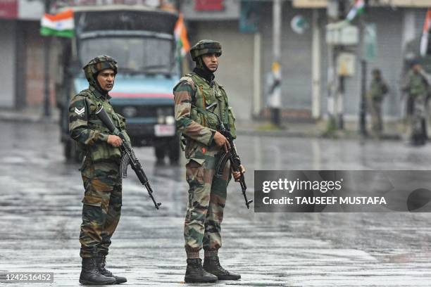 Indian paramilitary troopers stand guard along a street on the country's 75th Independence Day in Srinagar on August 15, 2022.