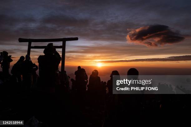 People watch the sunrise from the summit of Mount Fuji early on August 15 some 70 kilometres west of the capital Tokyo.