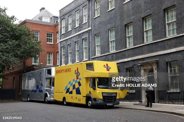 Moving trucks are parked outside Number 10 and 11 Downing Street in central London on August 15, 2022. Britain's outgoing Prime Minister Boris...