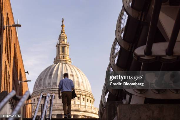 Commuter walks in view of St. Paul's Cathedral in London, UK, on Monday, Aug. 15, 2022. The Office for National Statistics are due to the release the...