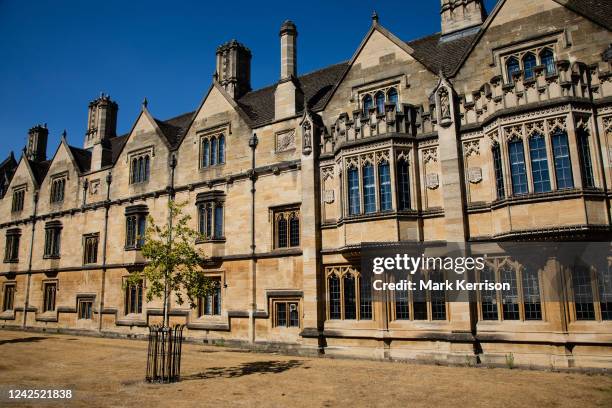 Parched lawn matches the colour of the yellow stone architecture of Magdalen College on 12th August 2022 in Oxford, United Kingdom. Hot and dry...