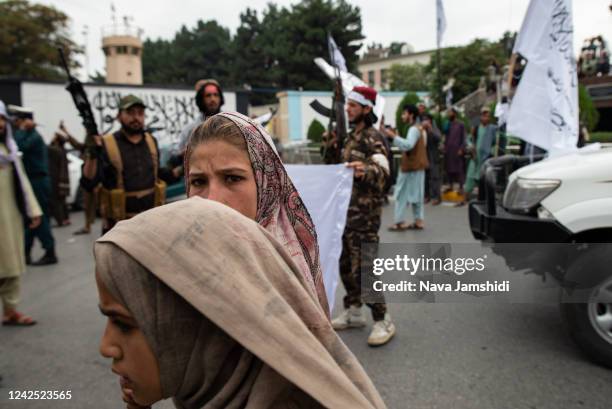 Women walk down the street during a celebration of the first anniversary of the Taliban's return to power on August 15, 2022 in Kabul, Afghanistan. A...